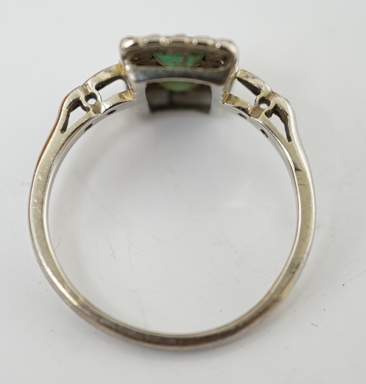 An Art Deco white metal, emerald and diamond set double cluster tablet ring, with diamond, set shoulders, size K, gross weight 2.6 grams.